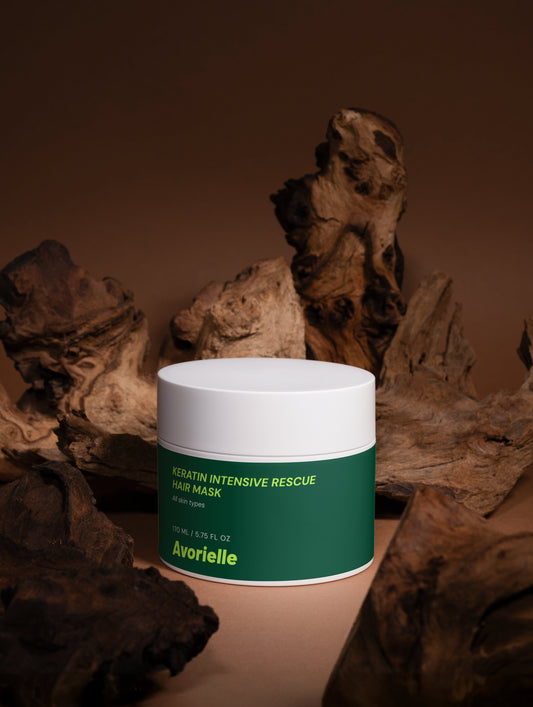Keratin Intensive Rescue Hair Mask for damaged hair positioned among natural textures, highlighting its nourishing formula.